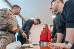 Инструктор по тактической медицине ДОСААФ России Павел Никифоров (крайний слева) объясняет, как правильно проводить тампонаду раны
