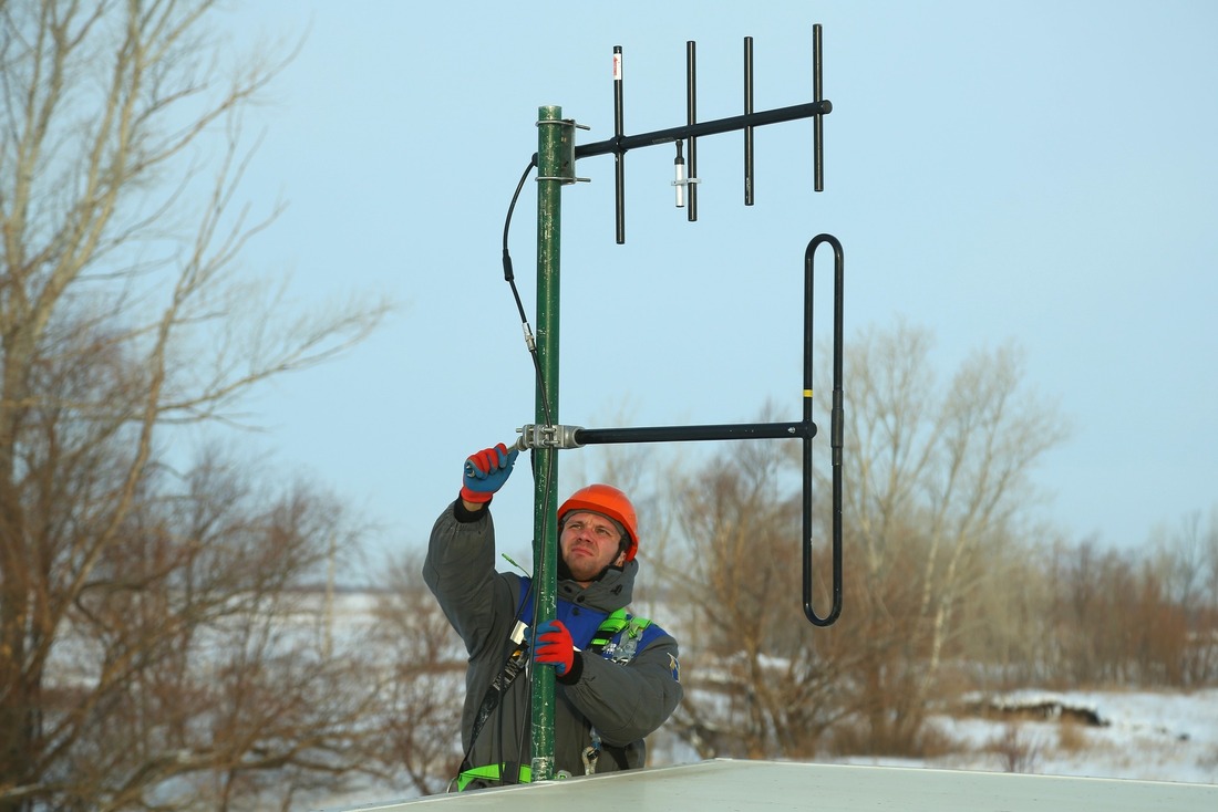 Антенщик-мачтовик Владимир Свиридов выполняет монтаж антенно-фидерного устройства на кузове мобильной лаборатории